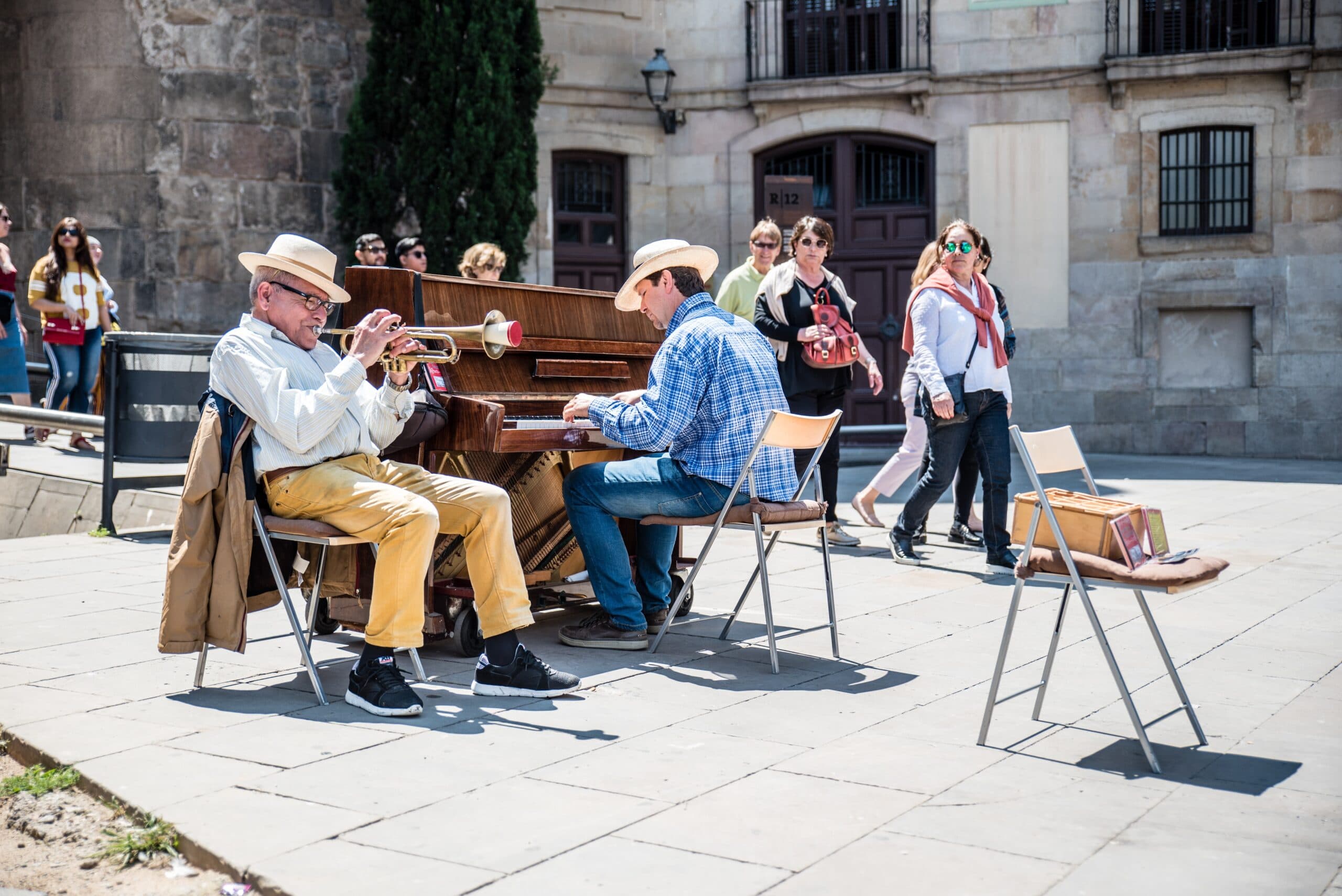 A piano being played outdoors for passers-by